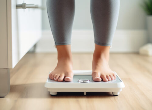 Photo of a woman's feet standing on a scale